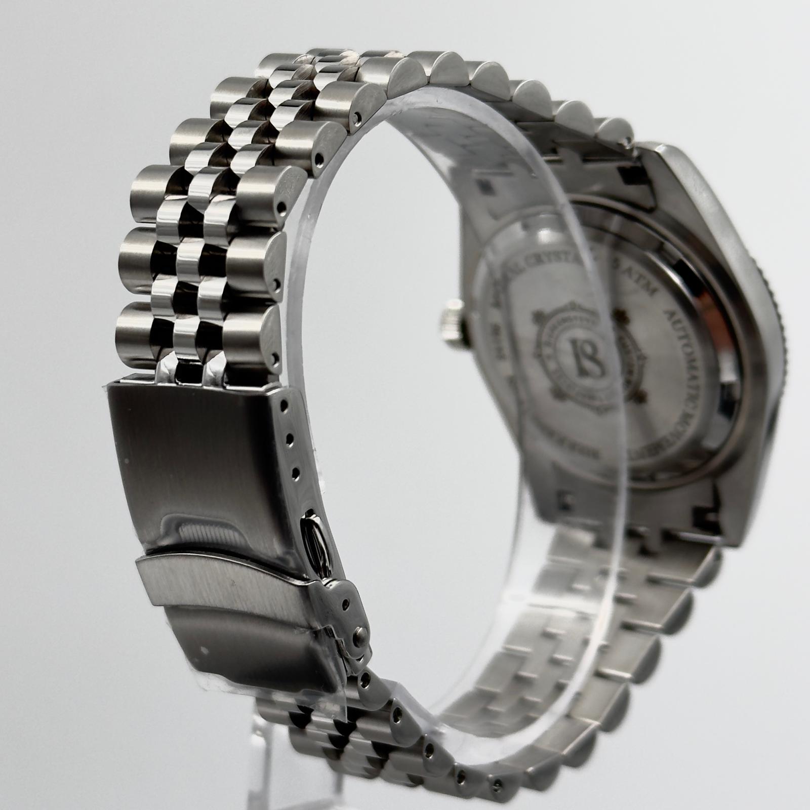 Side view of the stainless steel case of the Bierkensteyn Date 38 Blue, showcasing the fluted bezel and domed crystal