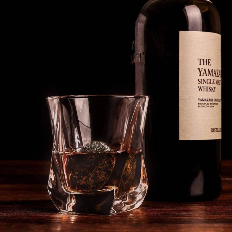 twist glass with whiskey and cooling rock