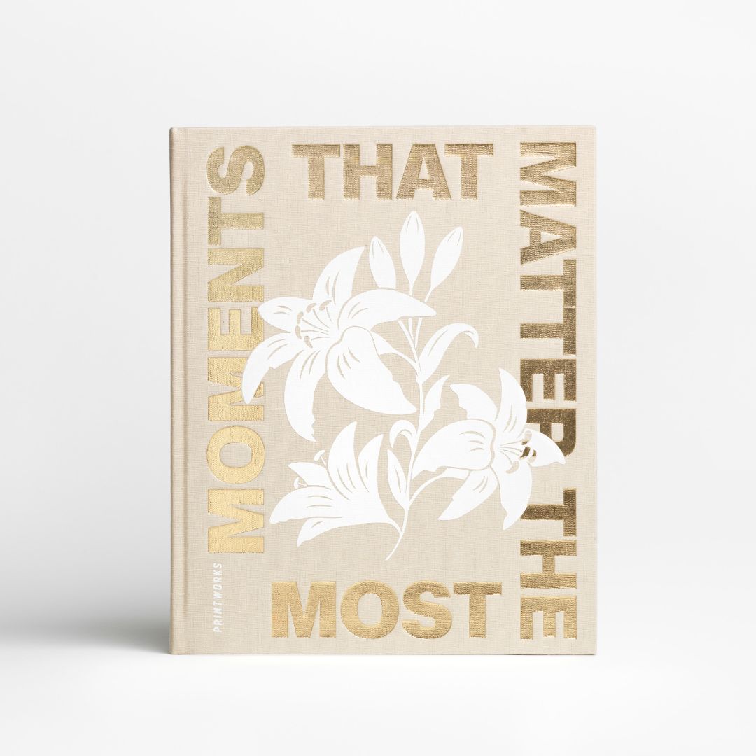 Beige coffee table photo album with gold foil text