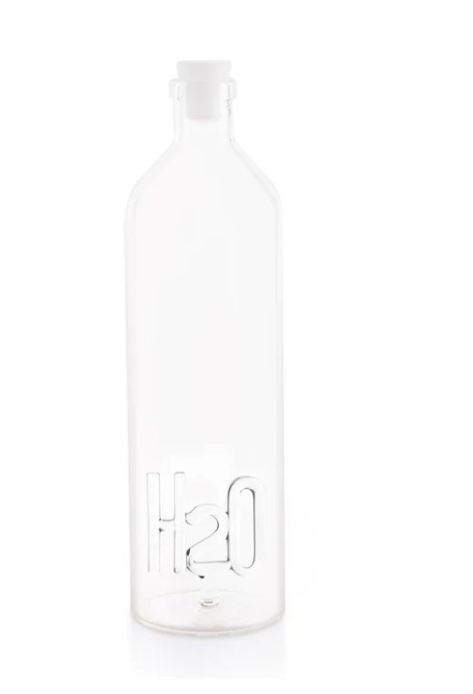 Minimalist borosilicate glass bottle with handmade glass H2O figurine inside, 1.2L, photographed in soft natural light.