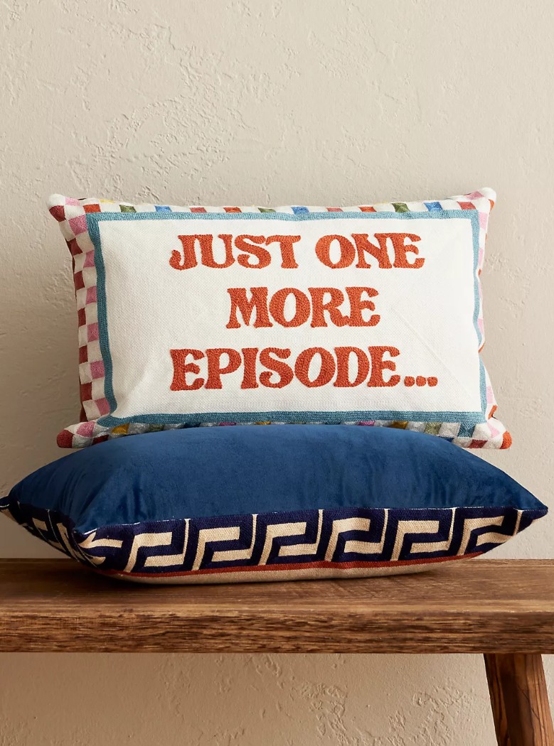 Just one more episode pillow the pillow drop on a wooden bench