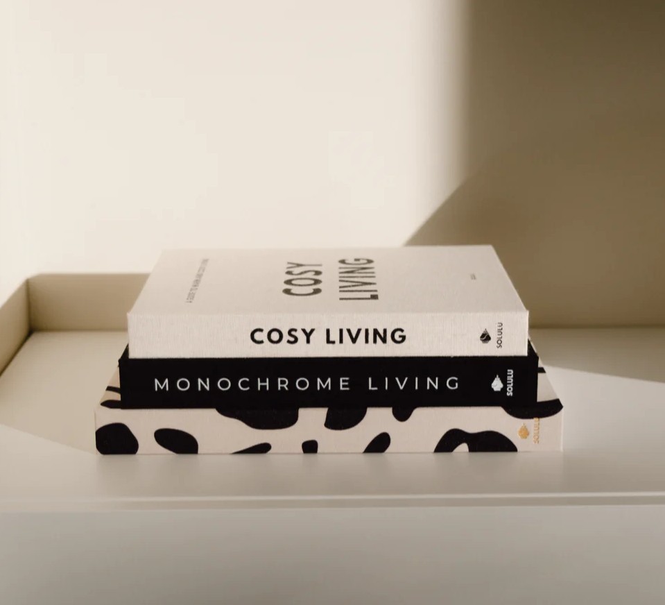 combination of the coffeetable books cosy living, monnochrome living and leopard on a shelf