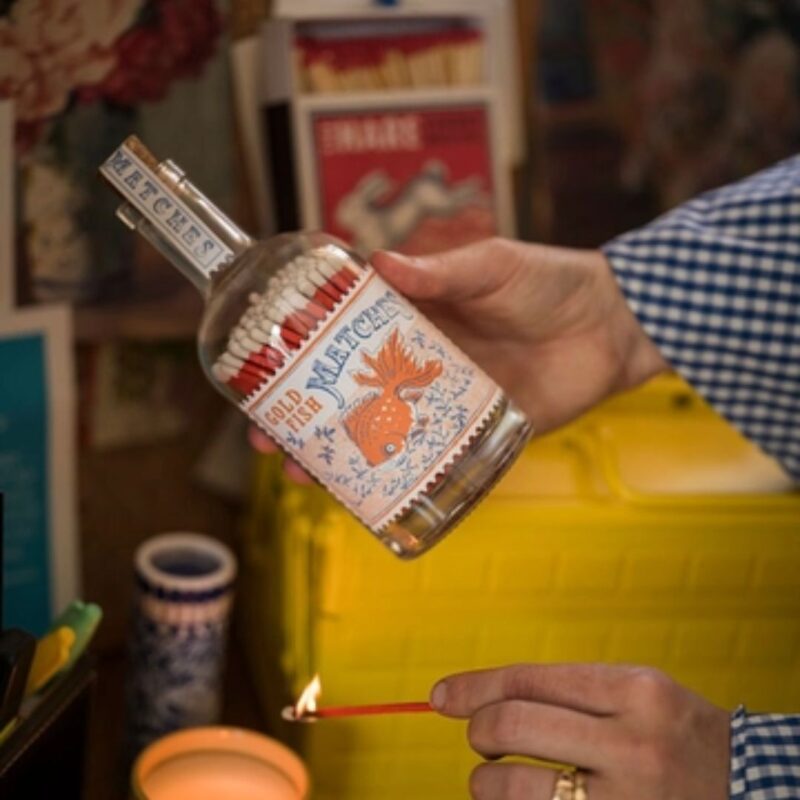 Goldfish matches in a bottle glass match bottle with vintage label and red matches