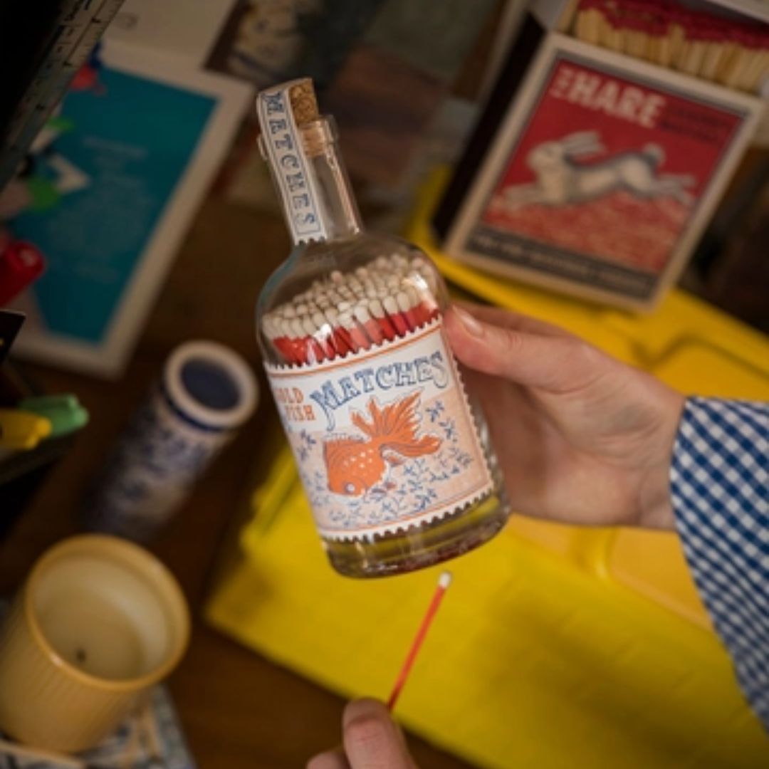 Goldfish matches in a bottle glass match bottle with vintage label and red matches