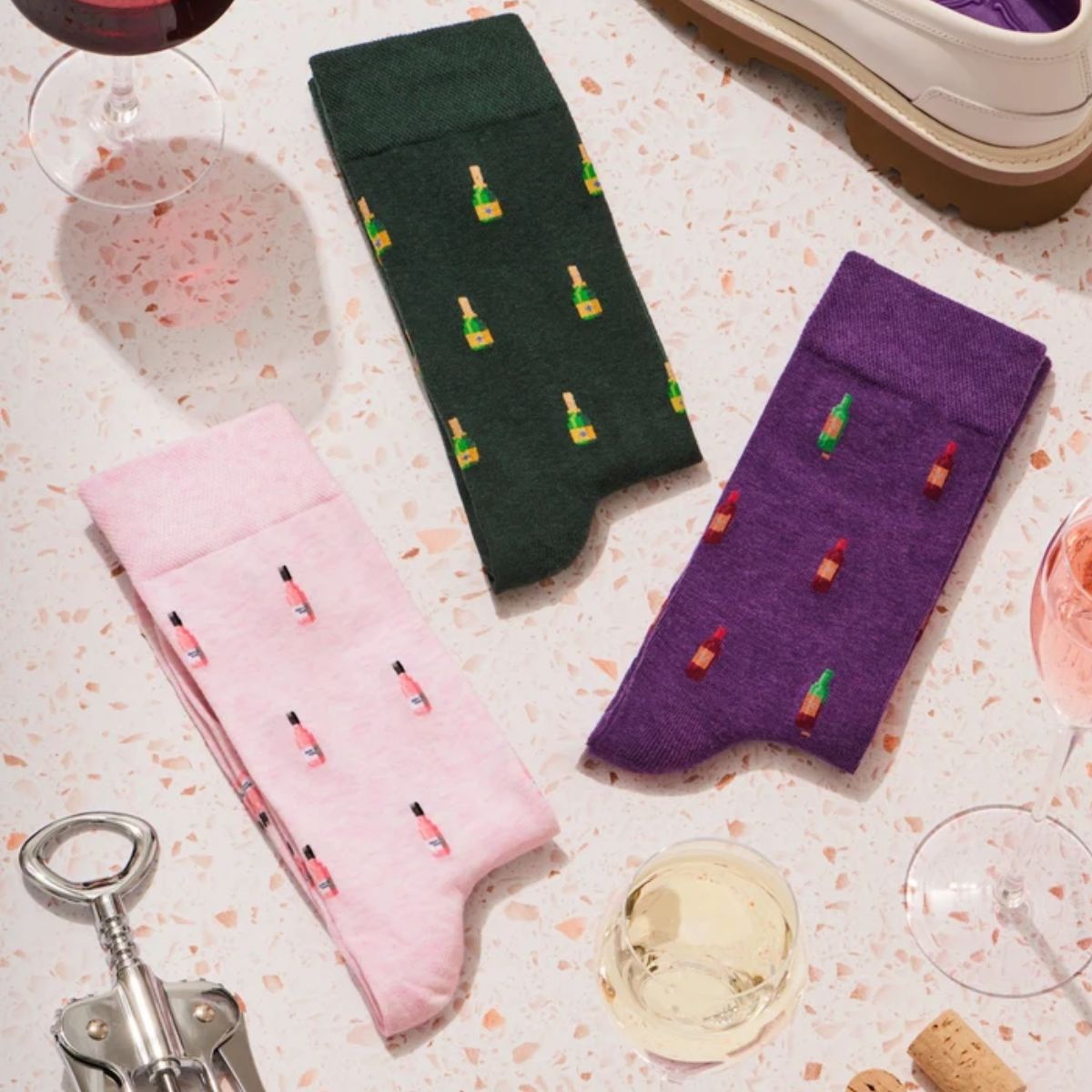 Three pairs of wine-inspired socks The Bubbles The Blush and The Sommelier