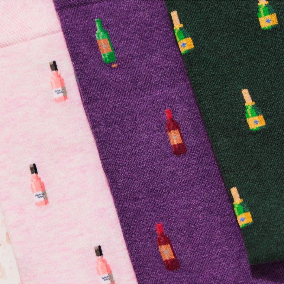 Three pairs of wine-inspired socks The Bubbles The Blush and The Sommelier